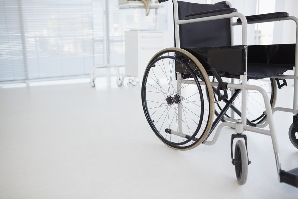Composite image of black wheelchair in hospital