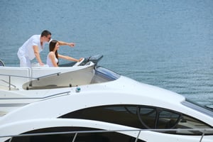 Romantic young couple spending time together and relaxing on yacht