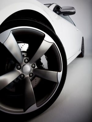 Picture of a white sports carÂ focusing on the tire